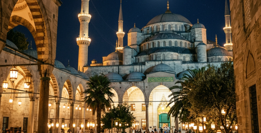 Blue Mosque courtyard at night with illuminated arches, minarets, and crescent moon